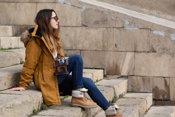 Fototapeta premium Photo of young tourist girl exploring streets of Baku. Moody photos of teenager girl visiting old city and taking photos of the city