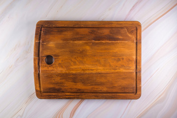 Wooden cutting board on a gray marble background