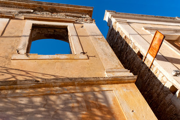 Abandoned neoclassical buildings on the Greek island of Symi.  Elegant buildings, once home to prosperous owners.  Now ripe for renovation by new owners.