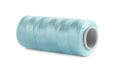 Spool of light blue sewing thread isolated on white