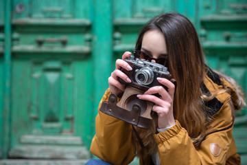 Photo of young tourist girl exploring streets of Baku. Moody photos of teenager girl visiting old city and taking photos of the city