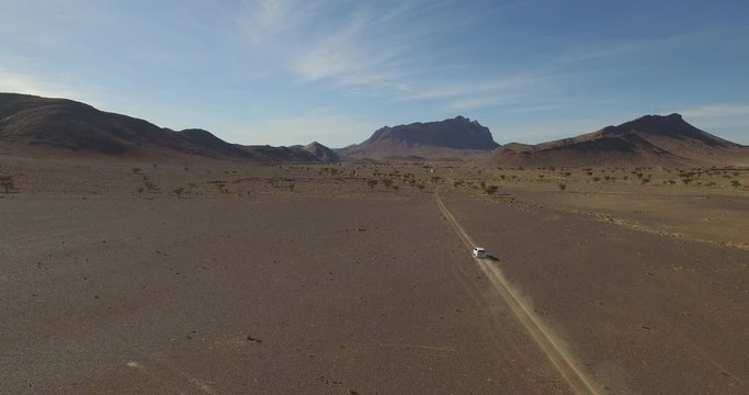 Drone footage of off-road vehicle driving on a desert road, Erg Chebbi, Morocco