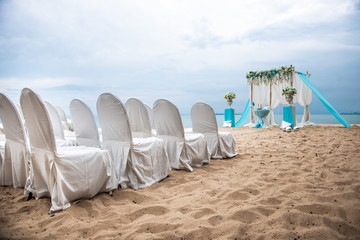 Outdoor wedding ceremony. Decoration of the arch with flowers on the beach