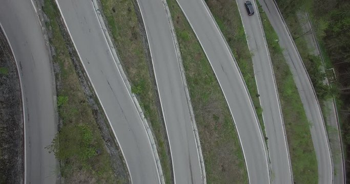 Aerial view of cars moving on windy road, Spluegen Pass, Italy