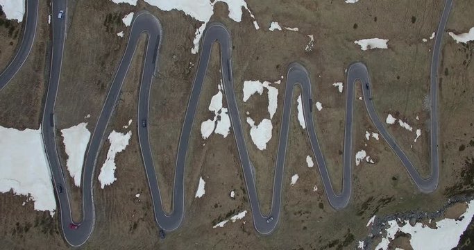 Aerial view of cars moving on winding road during winter, Spluegen Pass, Switzerland