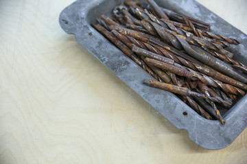 rusty drills in box on plywood background with copy space top view