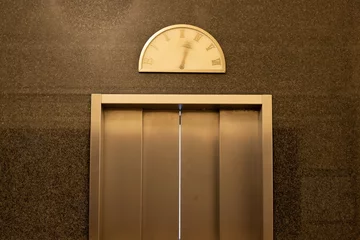 Detail of an elevator door with moving pointer on a vintage floor level display © Felix Busse Phtgrphy