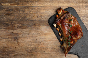 Delicious roasted ribs served on wooden table, top view. Space for text