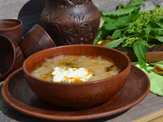 Stringing nettle soup, green borsch with nettle of spring