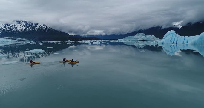 Drone footage of people kayaking in water with icebergs, Alaska, USA
