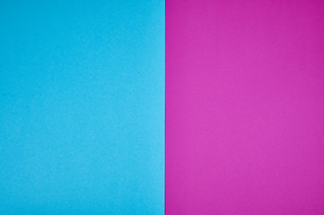 blue and magenta colored papers laid together as background photo with copy space