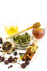 Medicinal herbal tea with honey on white background. Traditional treatment of flu and cold. Alternative medicine. Medicinal herbs.