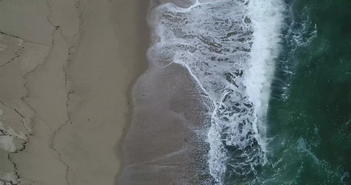Aerial footage of waves rolling on shore at beach, Tayrona National Park, Colombia