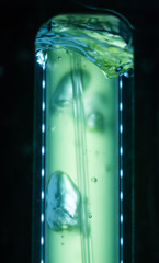 Test tube of yellow green liquid water