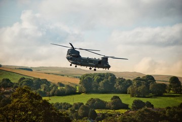 Fototapeta na wymiar Chinook helicopter in flight, flying over the Peak District countryside