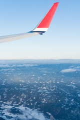 Fototapeta premium Wing aircraft in blue clear sky during flight
