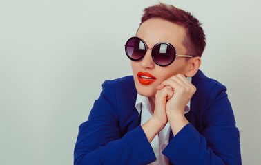 Woman in sunglasses posing isolated on a yellow background
