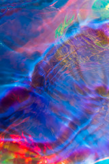 Multicolored iridescent water ripple conceptual photo