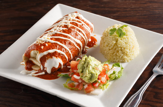 Mexican Carne Asada Burrito Served With Rice And Guacamole