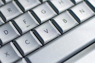 Silver keyboard on an old laptop