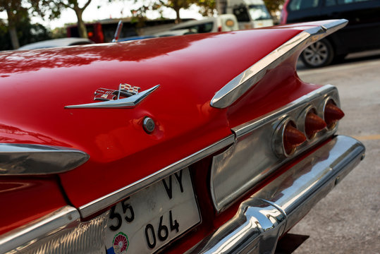 Rear view of a red colored 1960 Chevrolet Impala.