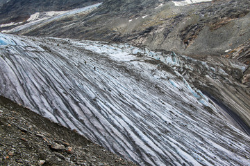 Two climber, hiker climbing on the Tre-la-Tete glacier in French Alps, near the Domes-de-Miage...