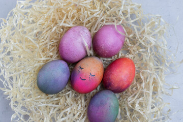 Fototapeta na wymiar on a gray concrete background eggs in straw Easter card
