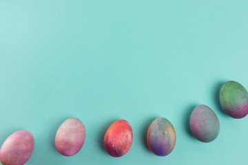 On a blue background multi-colored eggs for Easter