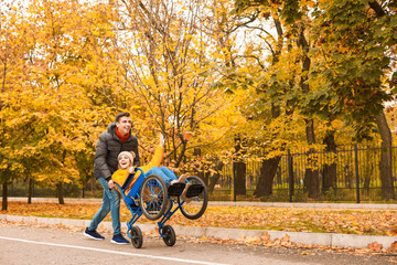 Handicapped young woman and her husband in autumn park