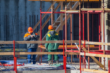 workers at the construction site of the building with armature