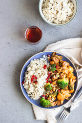 Curry chicken with rice, mushroom and broccoli decorated with pomegranate seeds. Healthy food. Asian cuisine.