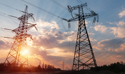 high-voltage power lines at sunset. electricity distribution station. high voltage electric transmission tower.
