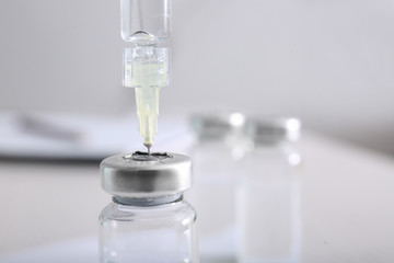 Syringe with filler for cosmetology and ampule, closeup