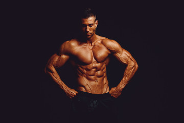 Fototapeta na wymiar Strong Muscular Men Posing and Flexing Muscles