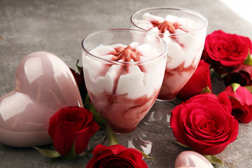 Strawberry dessert or ice cream in glasses and rose, decorated with hearts. Valentines Day background