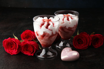 Strawberry dessert or ice cream in glasses and rose, decorated with hearts. Valentines Day background
