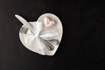 White heart on white dish. Meal on Valentines Day with fork