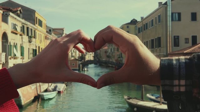 Italy framed by heart shaped hands of a couple. Travel, lifestyle concept. Vintage color.