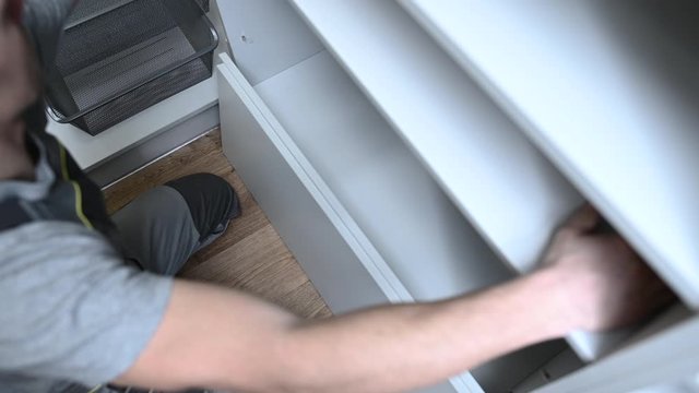 Caucasian Men in His 30s Finishing His Newly Remodeled Closet. Home Improvement Theme.