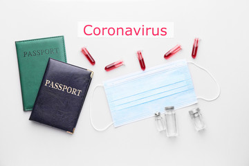 Protective mask with passports, blood sample and vaccine for Coronavirus on white background