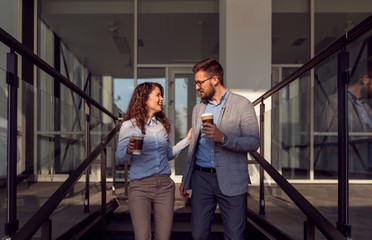Image of businesswoman and businessman with on break,holding coffee cup