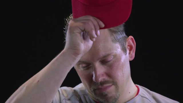 SLO MO, CU, Lockdown, baseball player wiping his forehead