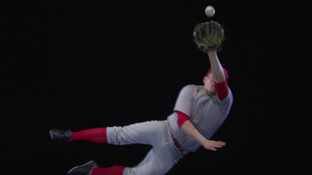 SLO MO, Lockdown, MS, baseball player diving to catch a ball and missing