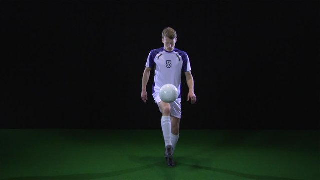 SLO MO, WS, Lockdown, soccer player kicking and kneeing a ball