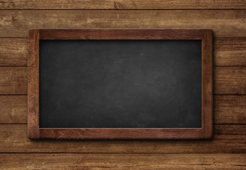 Small blank slate blackboard black color wooden background