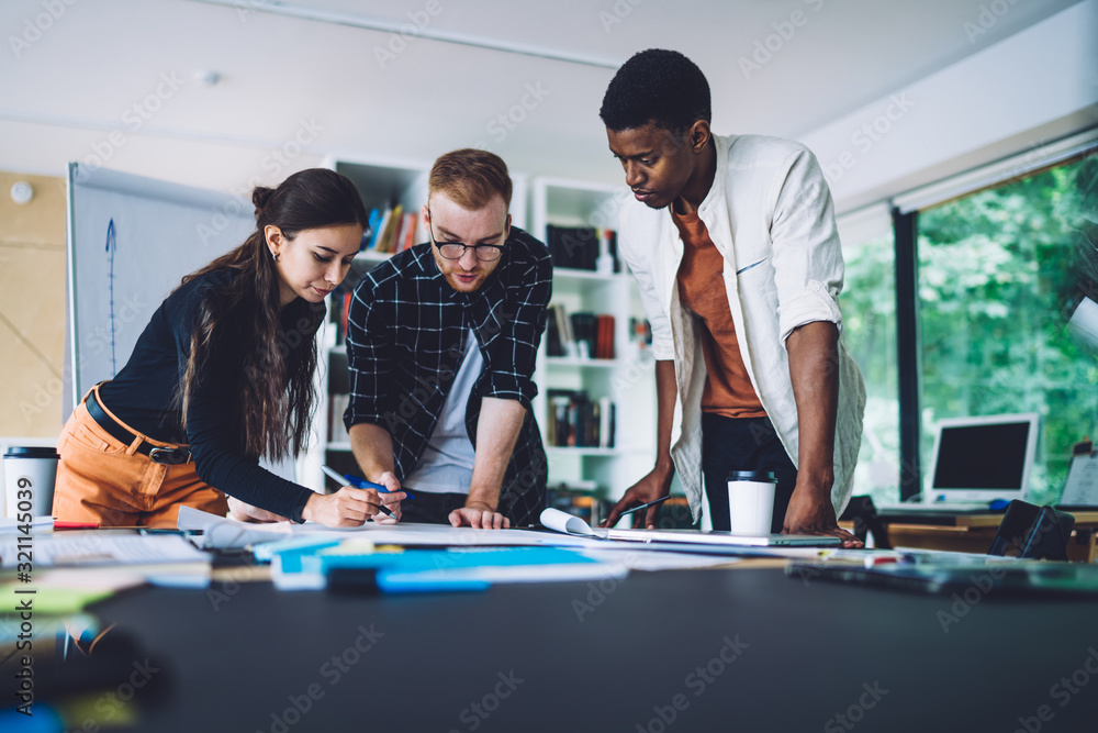 Poster group of smart casual developers working with project sketches for architect order, young colleagues