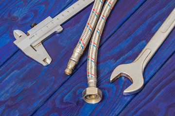 Necessary set of tools for plumbers on wooden blue boards with space for advertising