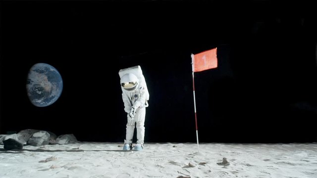 SLO MO, WS of an astronaut playing golf on the moon