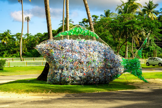 Huge white and blue public fish sculptures made from plastic drinking water bottles on the island of Tobago. An eco sign that we need to preserve world oceans. Save the planet.