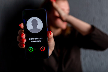 Phone call from unknown number. Scam, fraud or phishing with smartphone concept. Prank caller,...